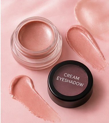 Cream eyeshadow in a small cosmetic jar with creamy texture and shimmer finish