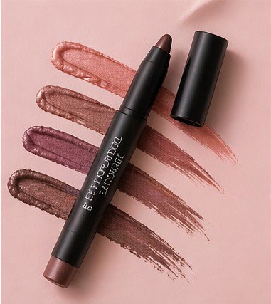 Eyeshadow stick on a pink flat lay background