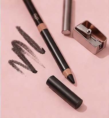 Kohl eyeliner pencil for smoky eye makeup on a soft neutral background