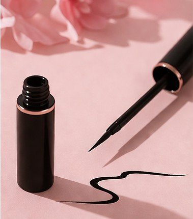 Liquid eyeliner pen with fine brush tip for precise winged eye makeup application