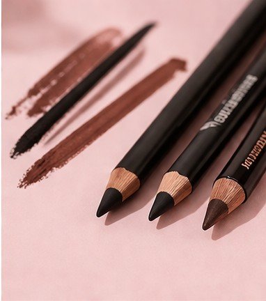 Pencil eyeliner pencil on a soft pink background for beauty makeup application