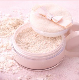 Setting powder with a puff to lock makeup and reduce shine